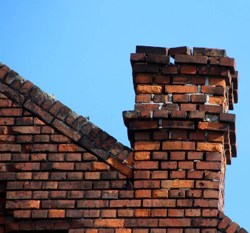 Damaged chimney on an Towson home showing cracks and missing mortar